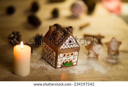 fairy Christmas house cake with candle light inside, narrow depth of field and background lights