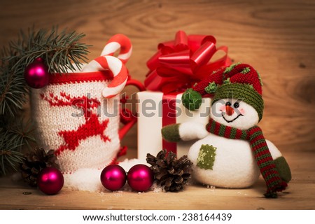 Mug Of Tea Or Coffee. Sweets And Spices. Christmas Decoration with snowman. Wooden Background.