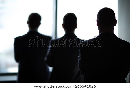 silhouette of three businessmen in the office