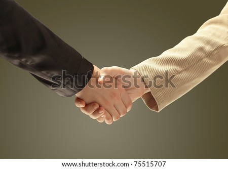 businessman\'s hand shaking white businessman\'s hand