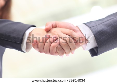 High angle view of business woman and man shaking hands