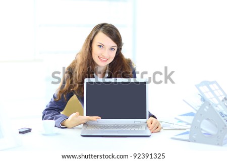 Nice business woman in the office, representation of the laptop.