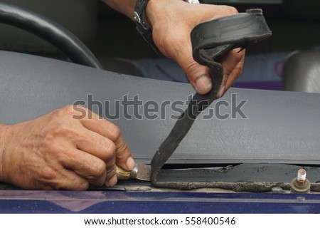 Glazier using tools repairing to fix crack broken windshield on the front window glass of the machine car accident.\Suction , Vacuum, Suction - Pads, Grippers, Cup Mountings.