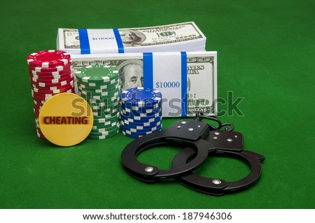 Stack of cash with poker chips and handcuffs