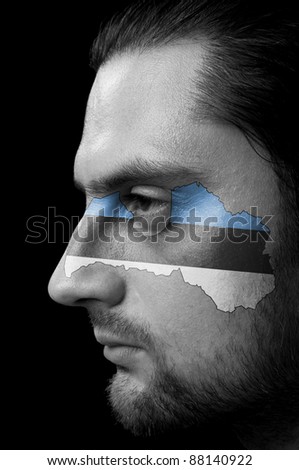Portrait of a men with the  Estonian Flag on his face.