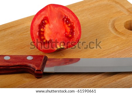 The tomato cut half-and-half and knife lay on a chopping board. Closeup. Isolated on a white background