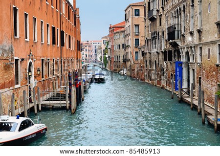 A canal in Venice showing two bridge and diminishing perspective.