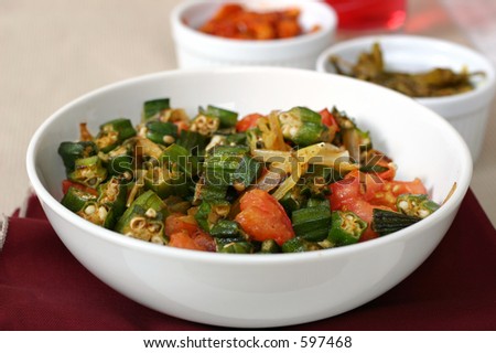 Traditional Indian dish of Okra shallow fried with tomatoes, onions and spices. Shallow DOF.