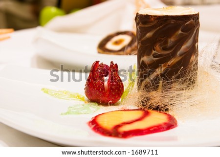 Lemon and Goldschlager Mousse presented in a trio of chocolate tower. Served with lemon curd, raspberry sauce and a strayberry flower.