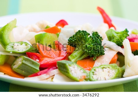 Vegetable salad greens made from broccoli, okra, cauliflower, red pepper lettuce and carrots. Shallow DOF.