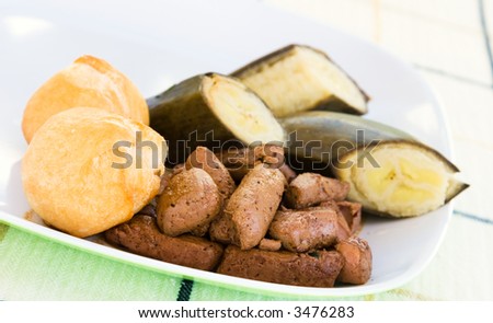 Caribbean dish of liver, served with fried dumplings and banana.