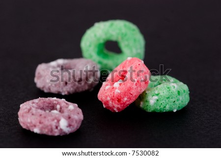 Breakfast Series - Frosted cereal rings against a black background.