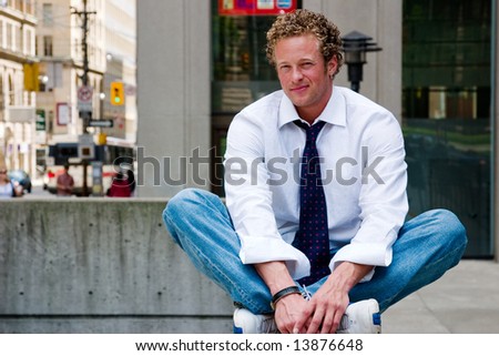 A young man relaxes in a downtown location