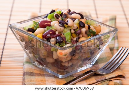 Healthy salad made with red kidney beans, black eyed peas, corn, spring onions, chickpeas, celery, and seasoning.