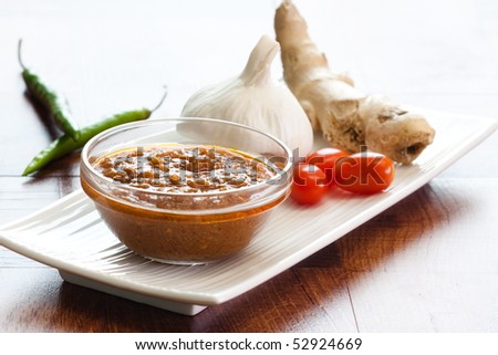 Bowl of vegetable curry sauce and all the ingredients that go into making it this classic Indian spice mix. Used widely in Indian food.