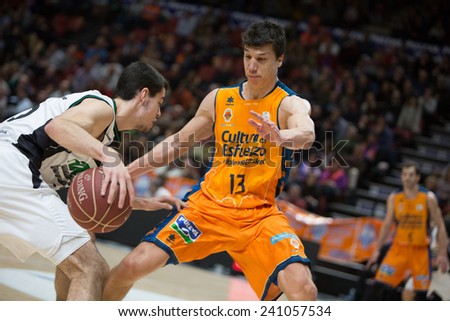VALENCIA, SPAIN - DECEMBER 30: Lucic (13) defends during Spanish League match between Valencia Basket Club and Juventut at Fonteta Stadium on December 30, 2014 in Valencia, Spain