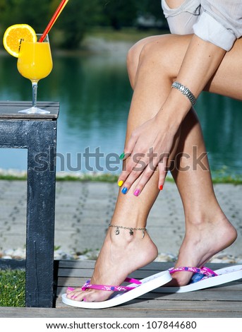 woman legs in terrace wearing summer flip flop sandals