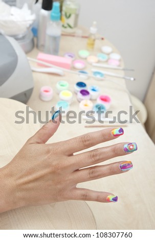 woman manicured hand with painted nails in salon