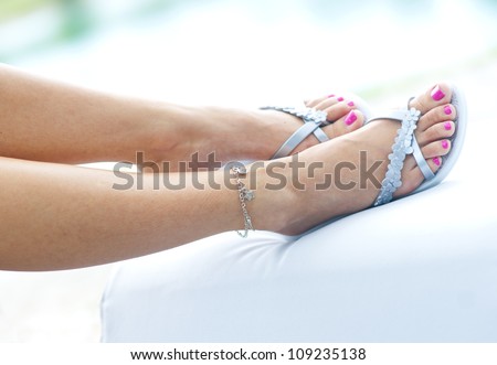 woman feet in summer flip flop sandals