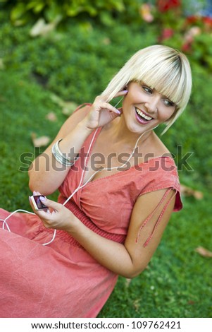 woman with mp3 player listen music outside