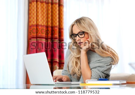 attractive woman writer in her home with laptop in creative process