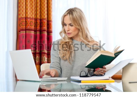 attractive woman writer in her home with laptop