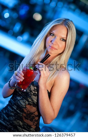attractive woman with cocktail in the bar or disco