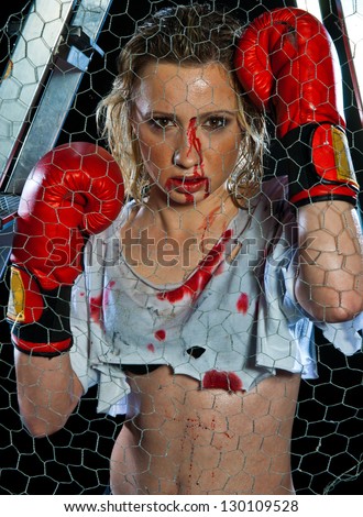 woman boxer in cage ring with bloody face