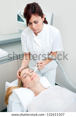 attractive woman in beauty salon on face lifting and anti wrinkles therapy