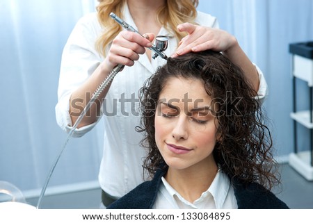 attractive woman in hair salon on fortifying hair treatment