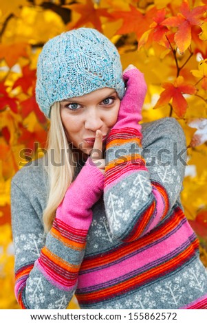 young teen girl wearing colorful sweater in autumn scenery