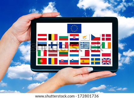 woman hands holding tablet with european union memer countries flags on screen and blue sky in background