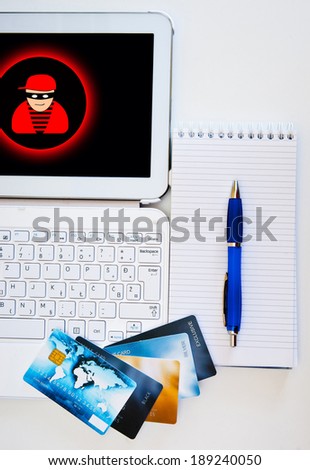 credit cards on computer with internet thief icon on the screen, concept for internet security