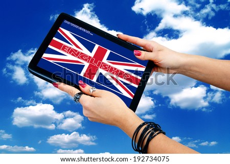 woman hand with jewelry holding tablet with english language sign on the screen