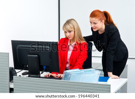 two attractive woman colleague workers in office working in computer