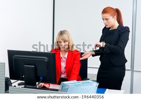 two nervous woman colleague workers in office working on deadline in computer