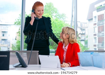 two nervous woman colleague workers in office working on laptop computer
