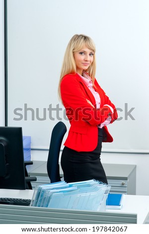 attractive blonde business woman in office workstation with computer