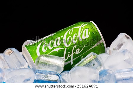 ZAGREB , CROATIA - NOVEMBER 19 ,2014 :   Coca-Cola Life can splashed with water on ice cubes in black background, product shot