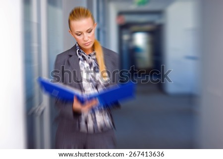 business woman with documents in the office, zoomed for dramatic effect