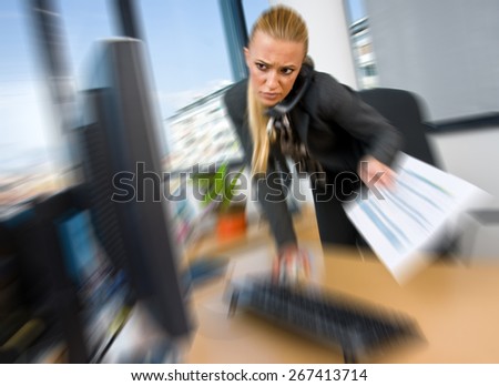 business woman working on computer in office, zoomed for dramatic effect