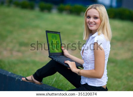 woman with recycle sign on computer