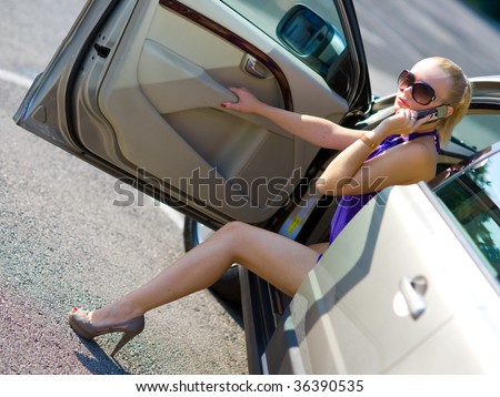 woman with beautiful legs exit the car