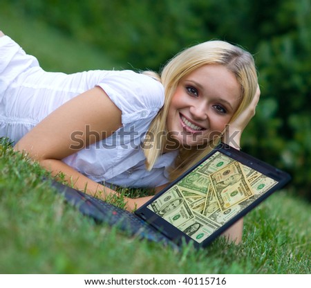 woman with recycle sign on laptop on the grass