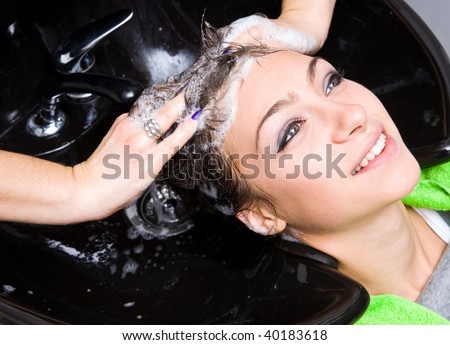 woman washing hair in hair salon
