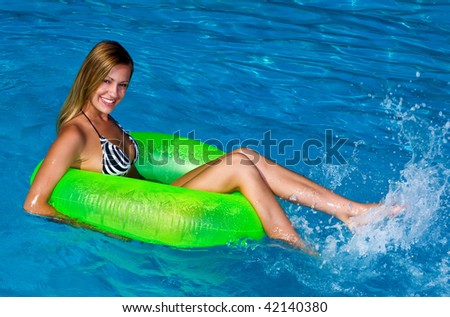happy woman in the water on floating toy