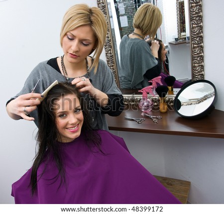 hair stylist work on woman hair in salon