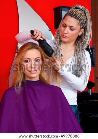 stylist work on woman hair in salon