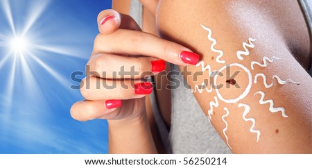 melanoma skin cancer on woman arm with sun in the background