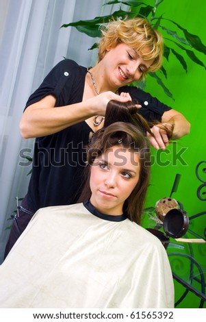 hair stylist work on woman in salon